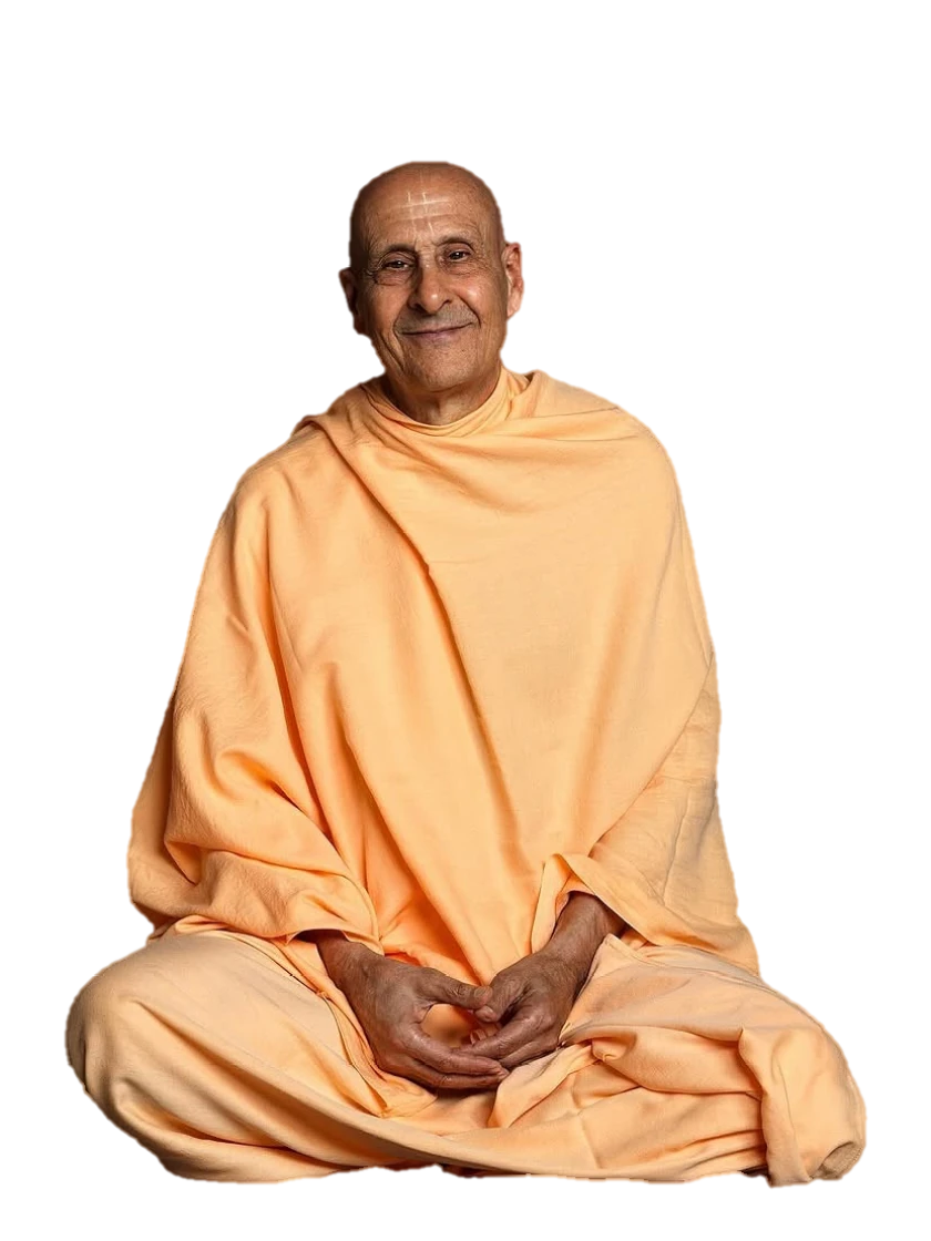 His Holiness Radhanath Swami Maharaj, seated and smiling, in saffron robes